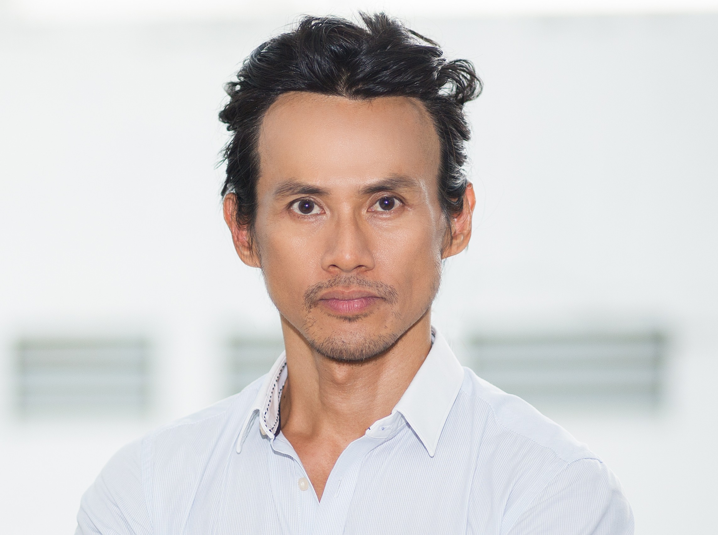 Closeup of Confident Asian Man with Arms Crossed